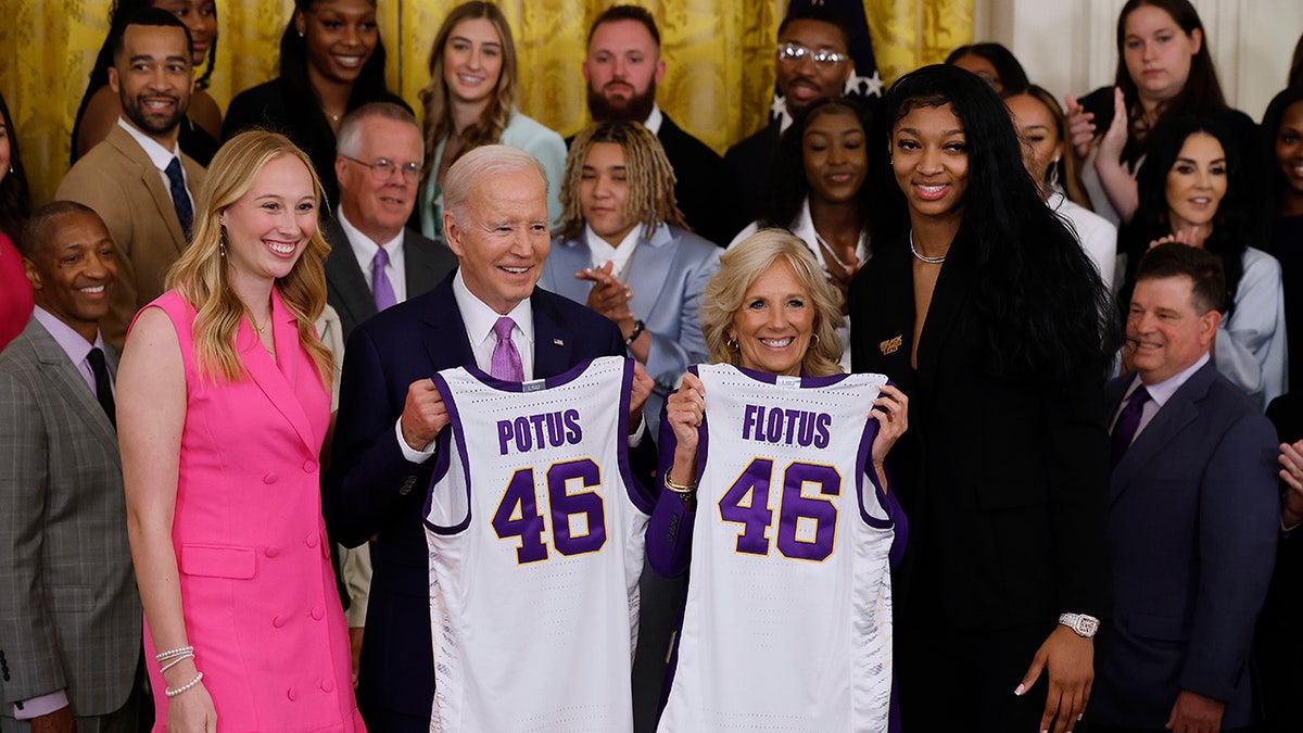 President Joe Biden and first lady Jill Biden pose for photographers with the LSU Tigers