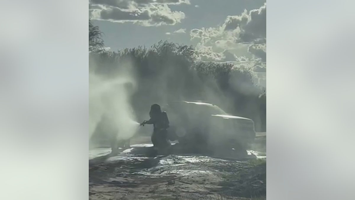 firefighter spraying foam