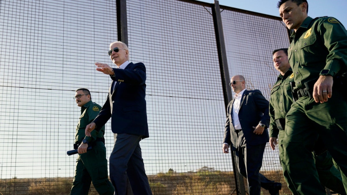 President Joe Biden walks on  a agelong   of the U.S.-Mexico border
