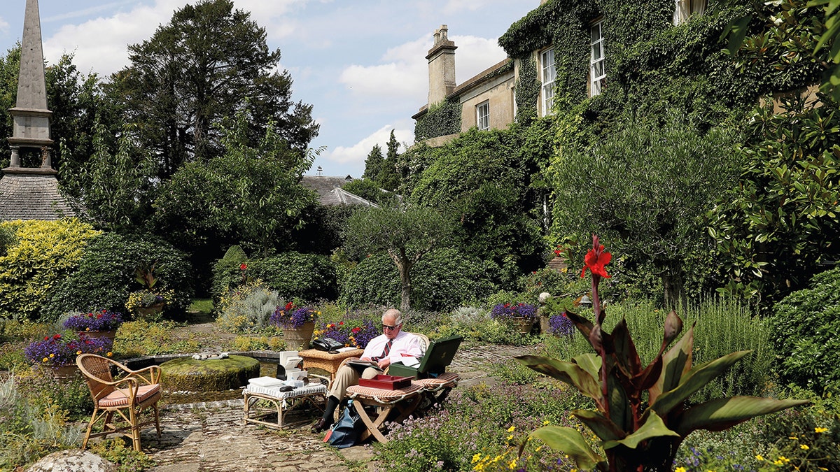 King Charles sitting in his garden