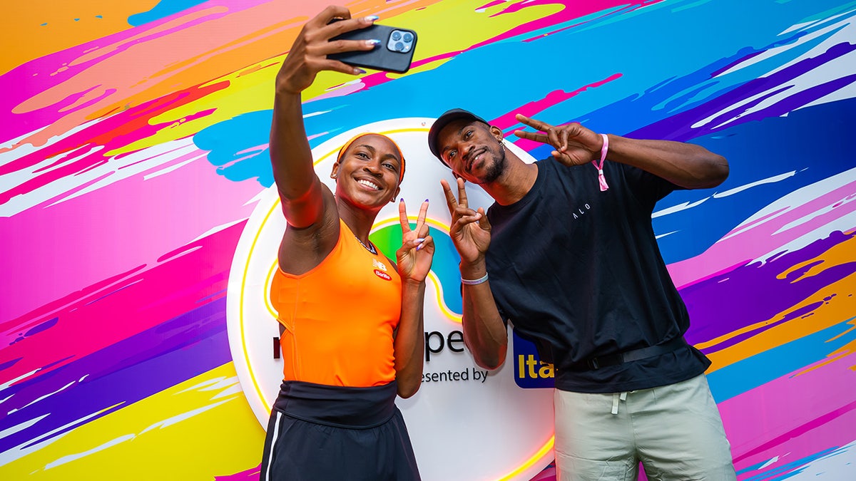 Coco Gauff takes a picture with Jimmy Butler