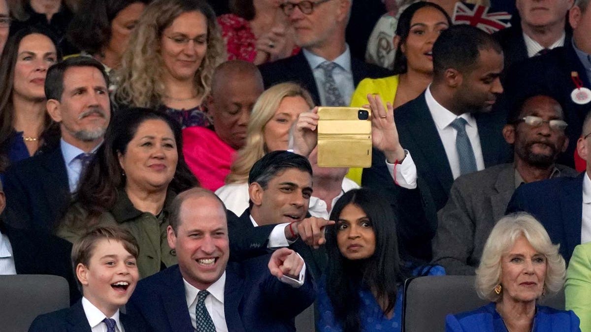 Prince George and Prince William point and laugh during coronation concert
