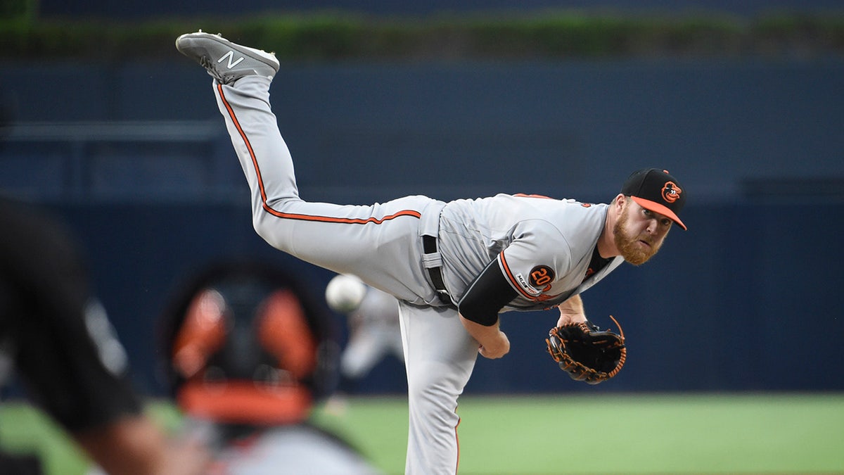 David Hess pitches during an Orioles game