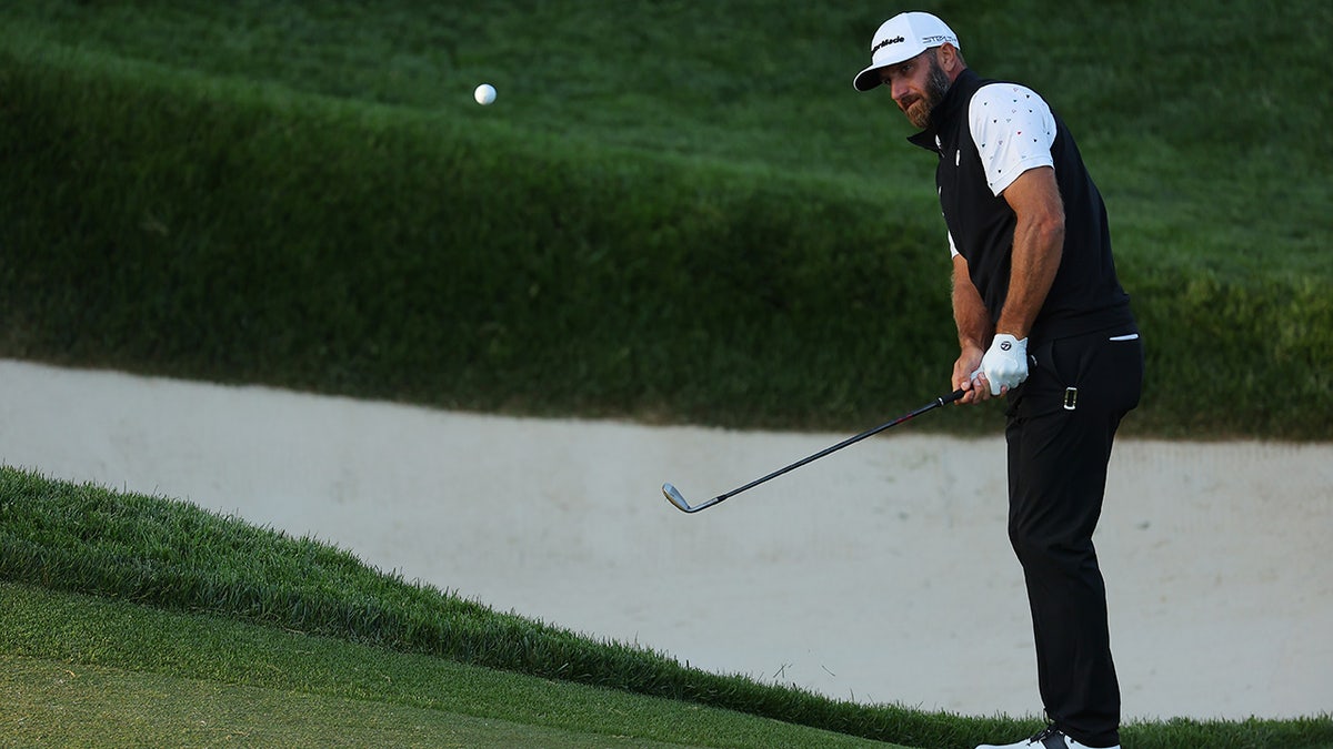 Dustin Johnson chips on the 13th green