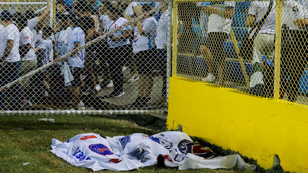 bodies covered with blankets at stadium