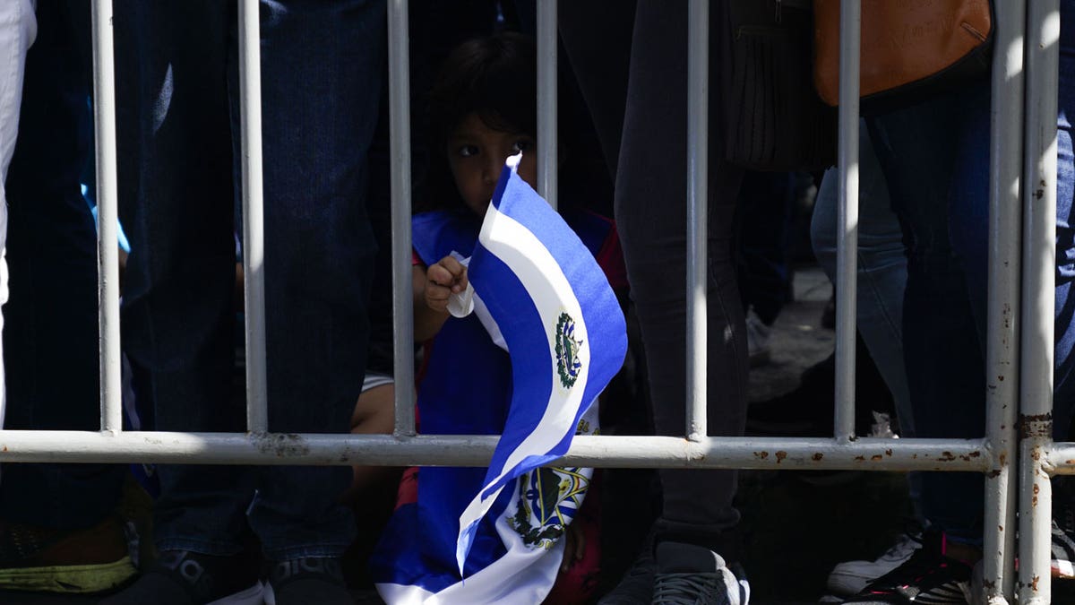 Child waving El Salvador flag