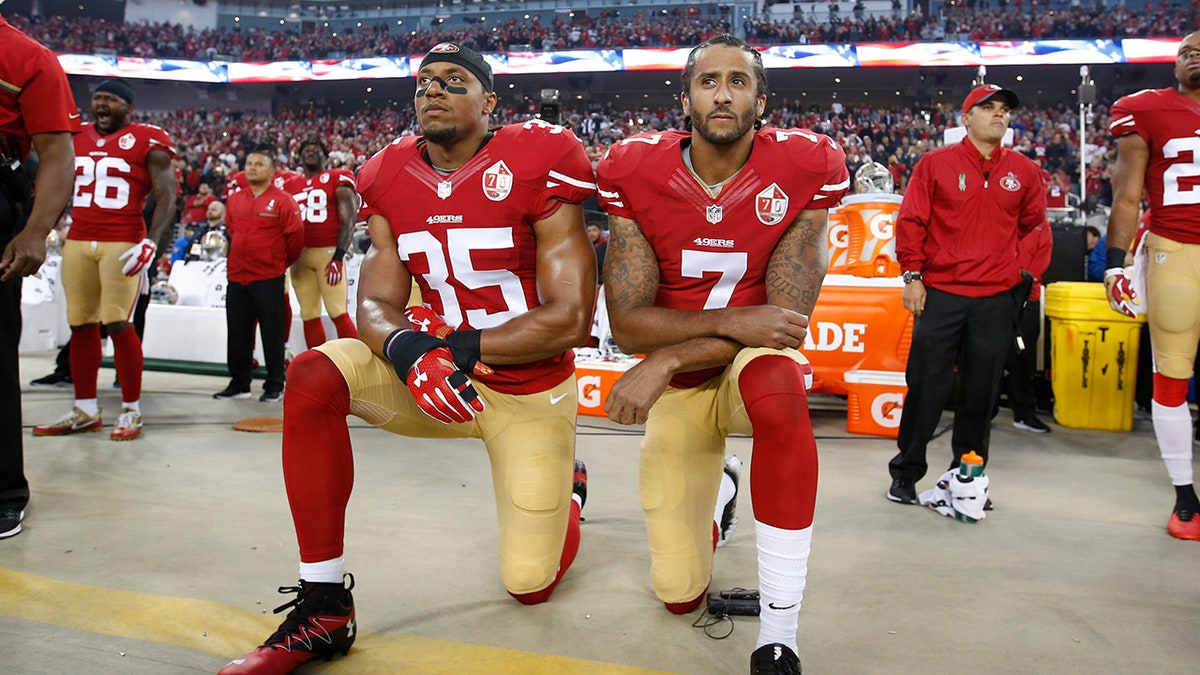 Eric Reid kneels with Colin Kaepernick