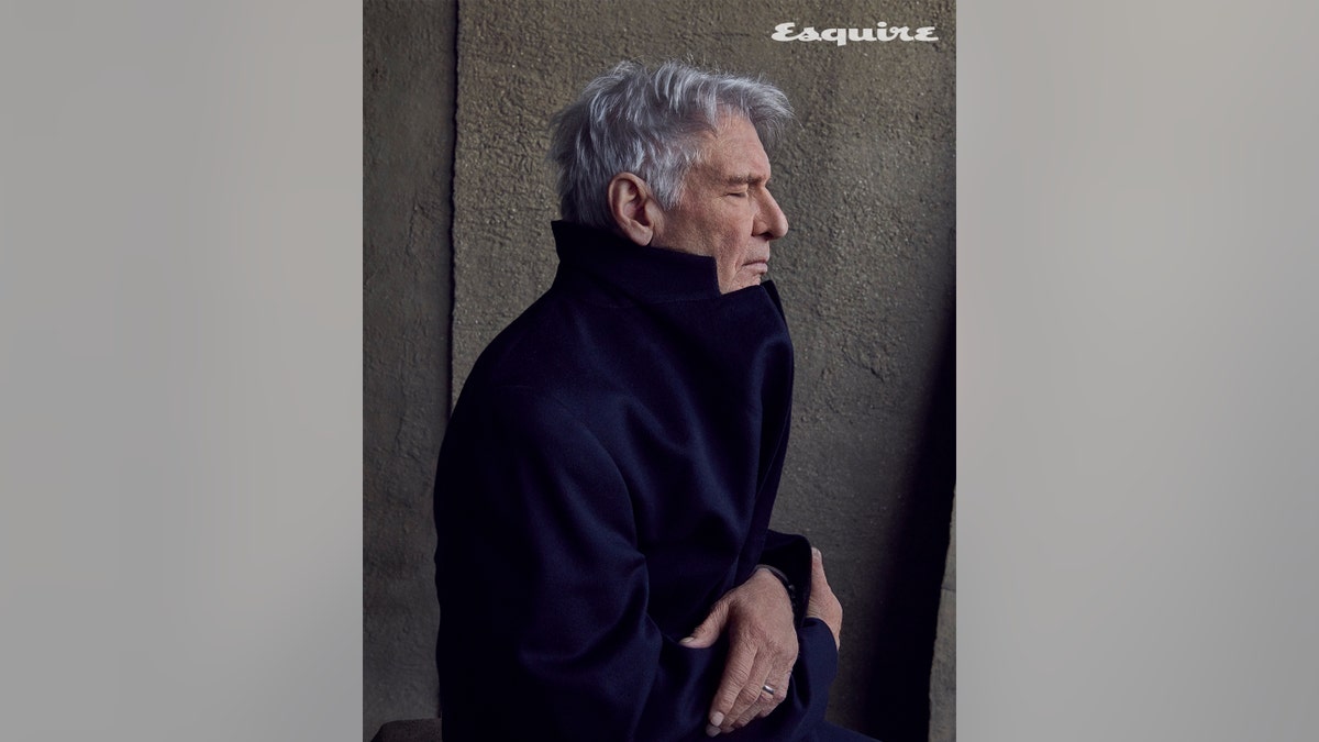 Harrison Ford wearing a jacket, closing his eyes in a photo for Esquire