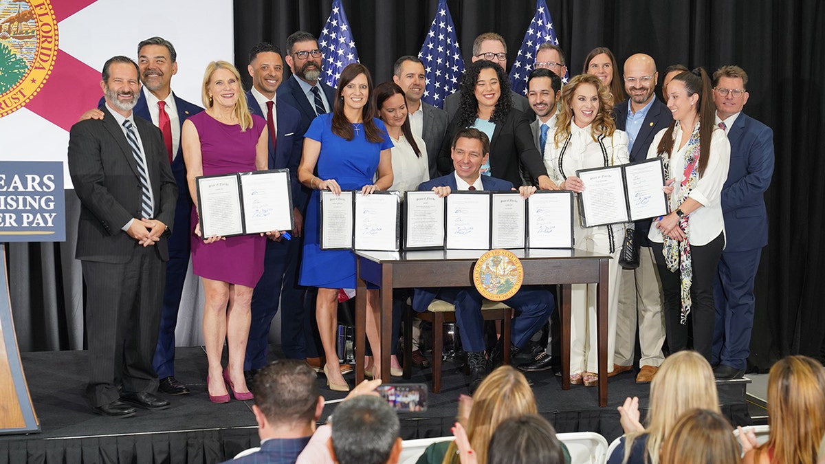 DeSantis signs legislation surrounded by supporters