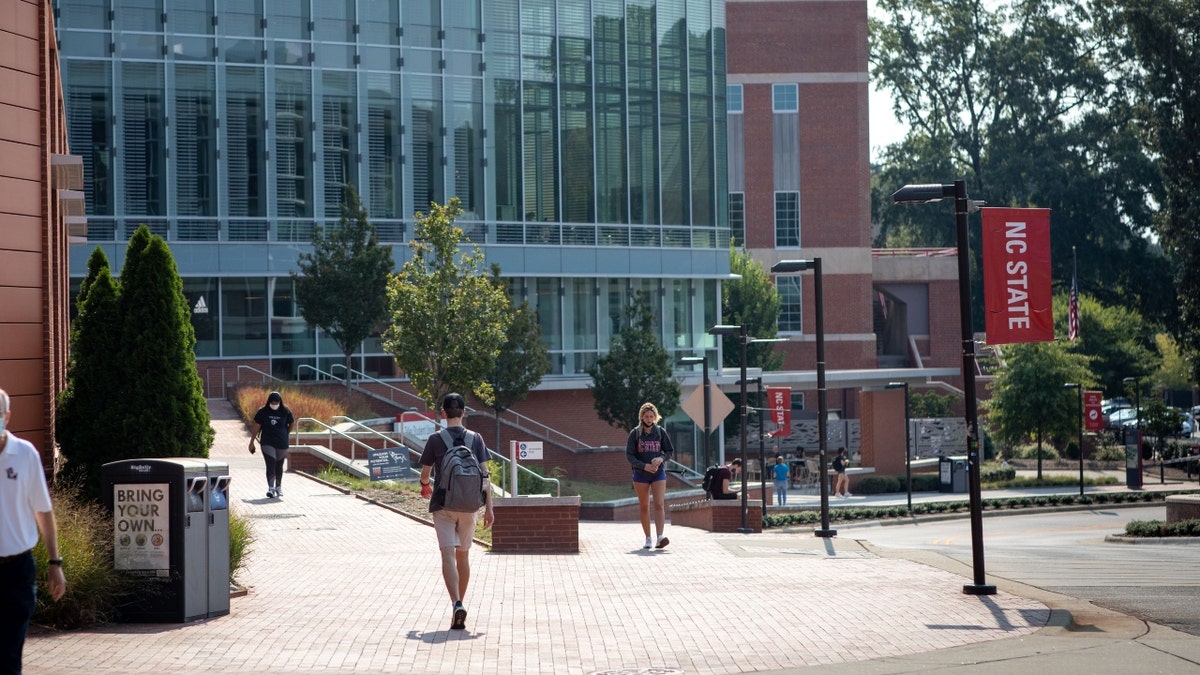 Students walk past the Tolley Student Center on campus at North Carolina State University in Raleigh, North Carolina, U.S., on Monday, Sept. 13, 2021.