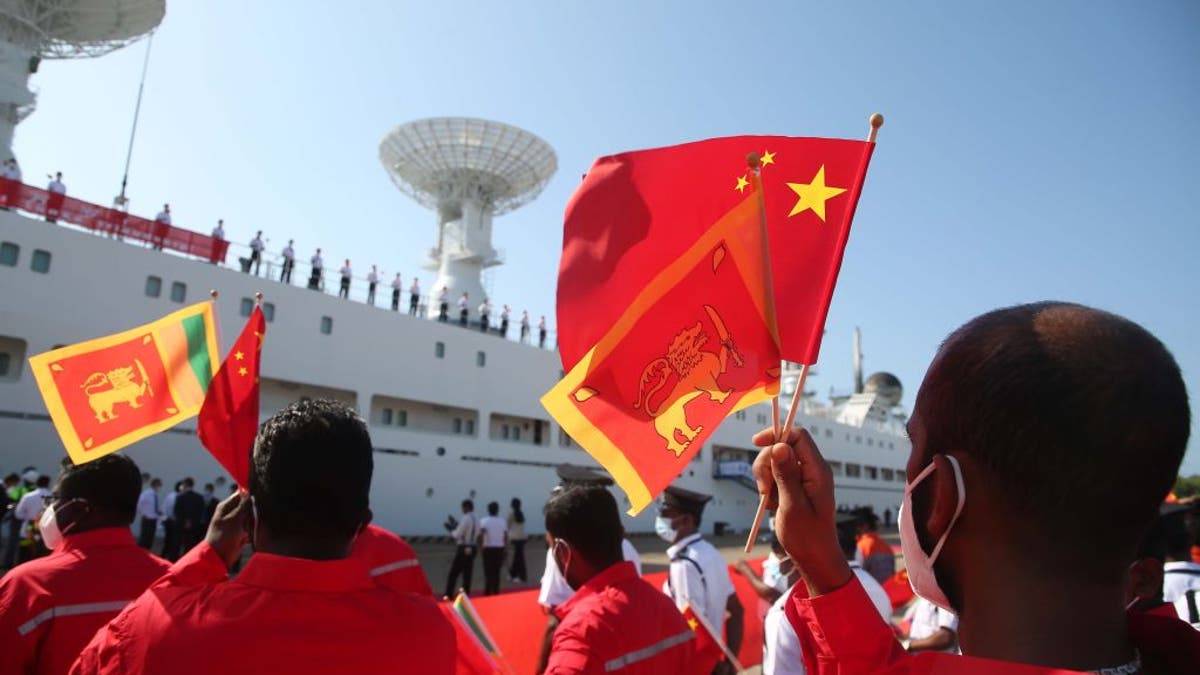 People wave Chinese flags in Sri Lanka