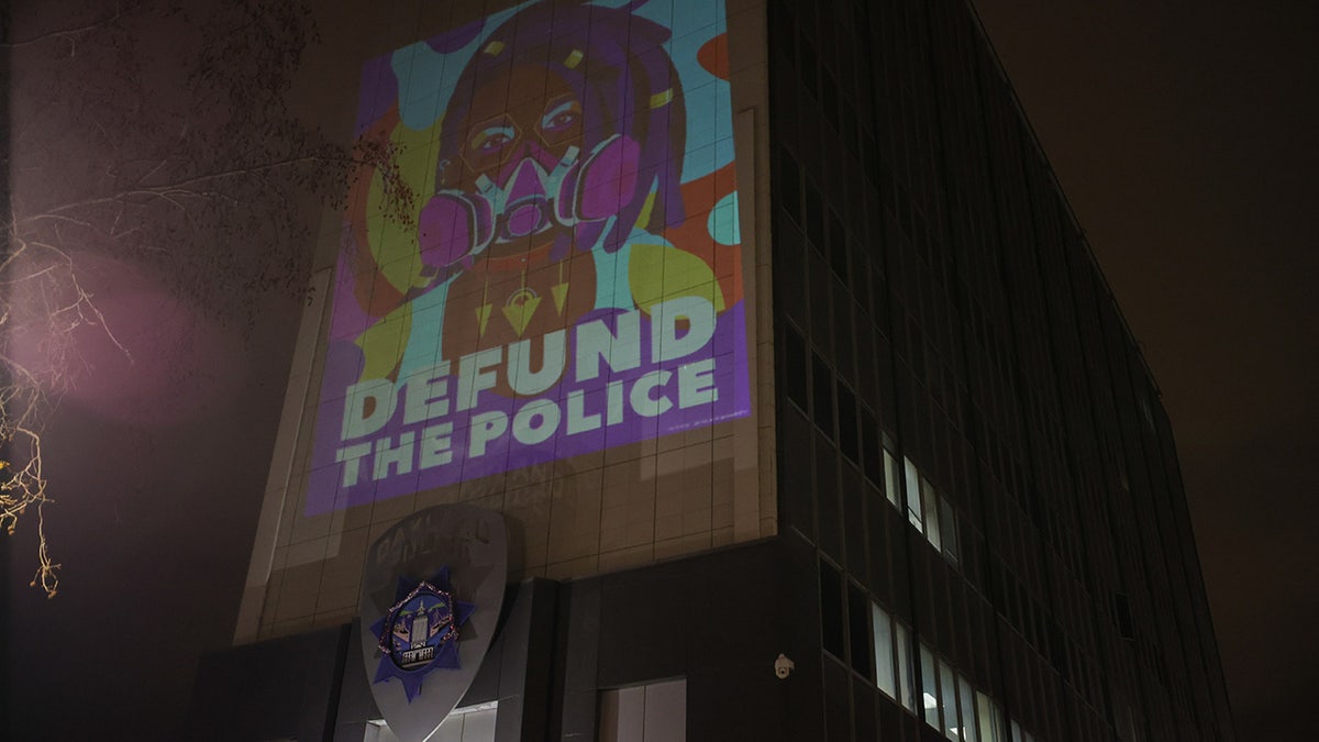 Defund the police logo projected at Oakland Police Headquarters