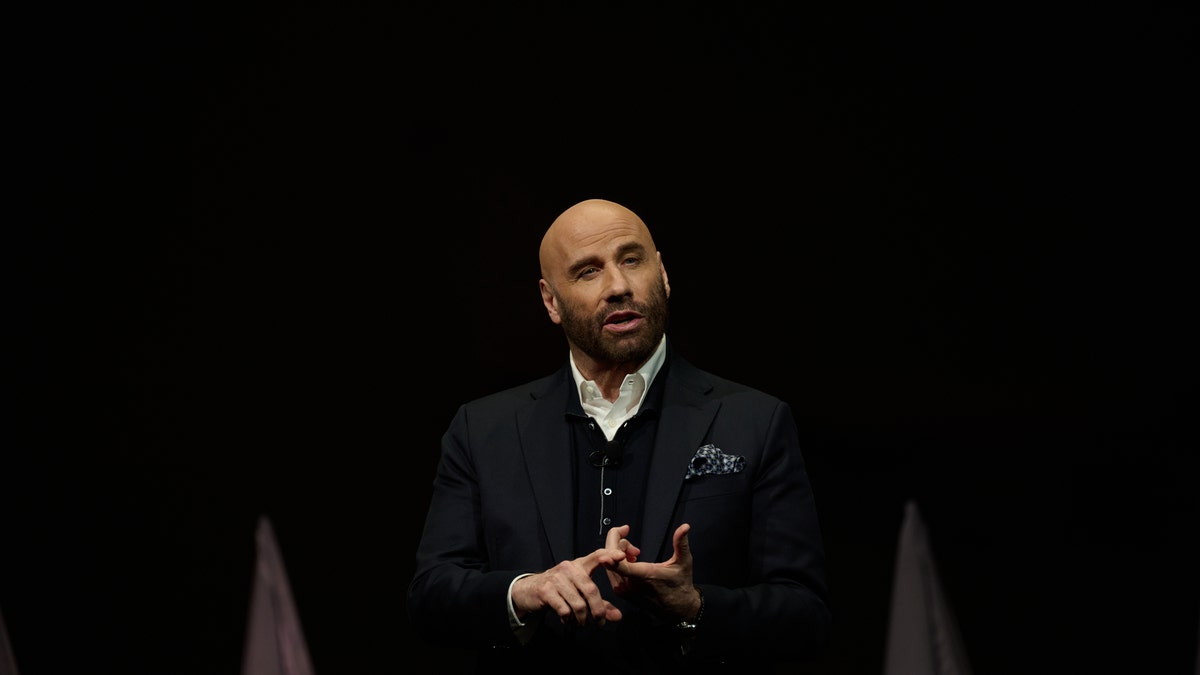 John Travolta presenting on stage