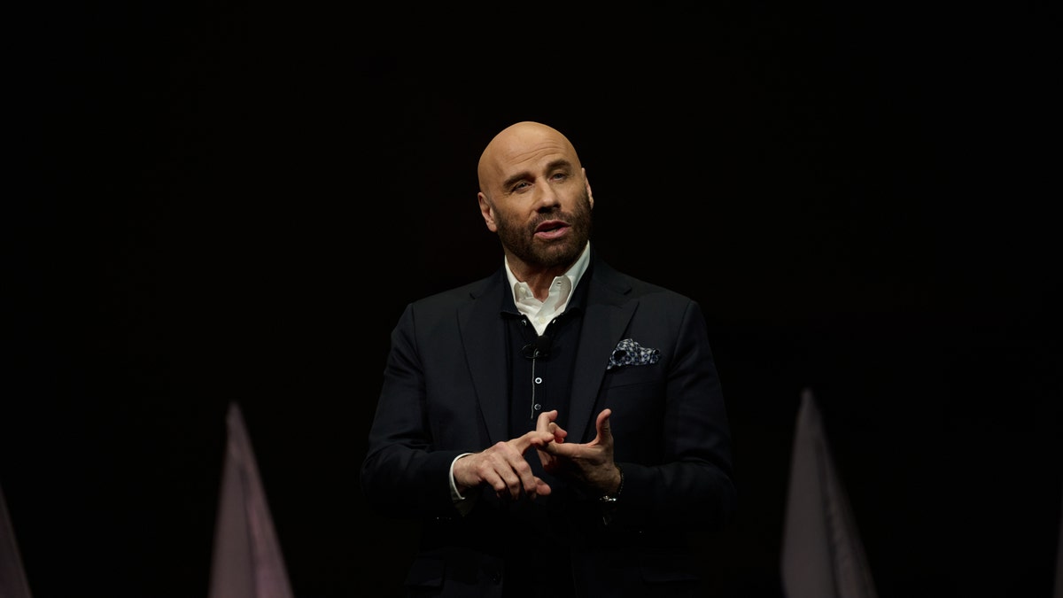 John Travolta presenting on stage