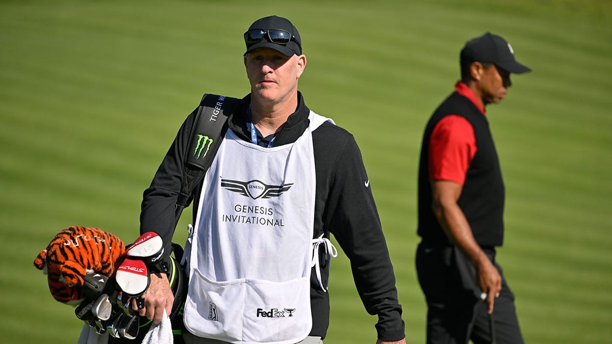 Tiger Woods walks with caddie Joe LaCava a the The Genesis Invitational