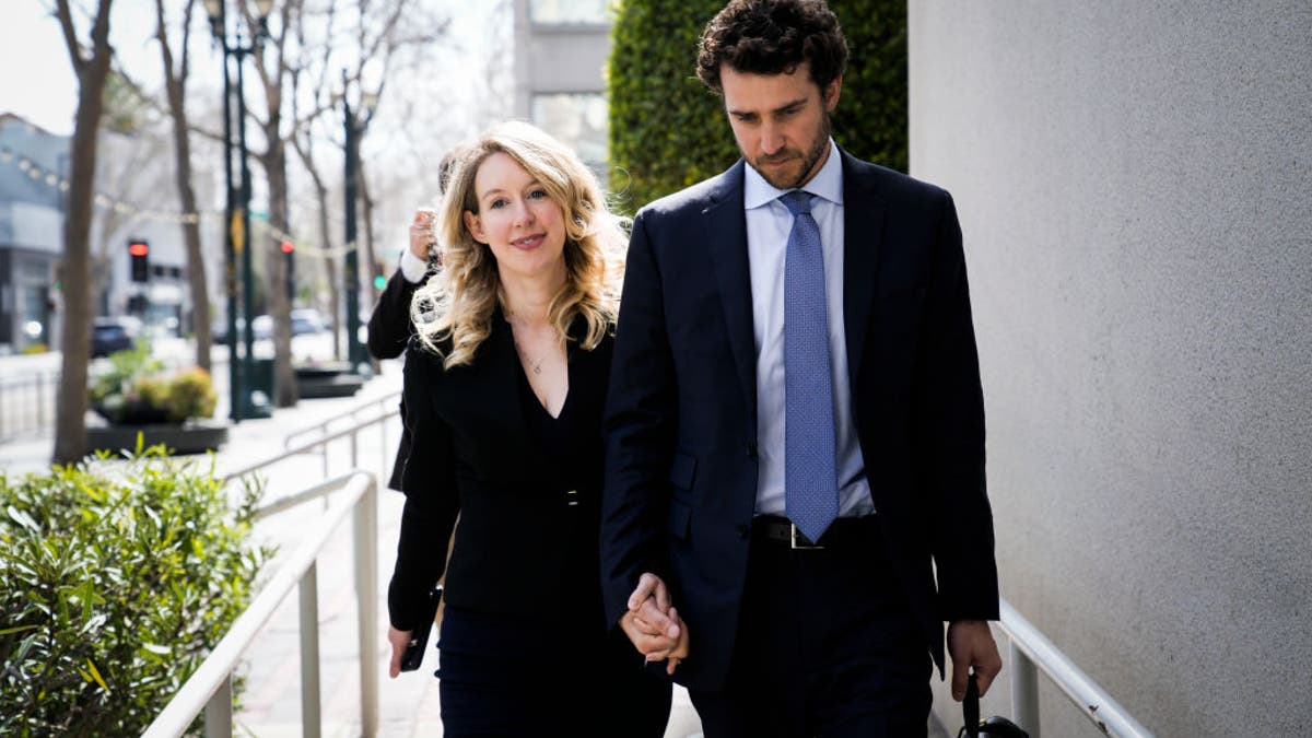 Elizabeth Holmes and Billy evans leave courthouse