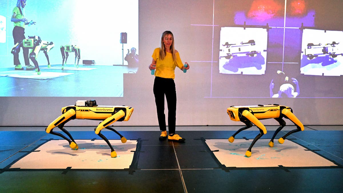 Agnieszka Pilat demonstrates Boston Dynamics robots painting through AI tech in Melbourne.