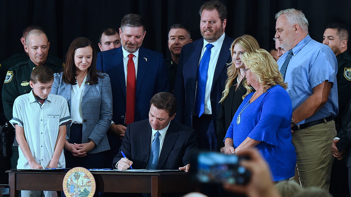 DeSantis signing a bill into law