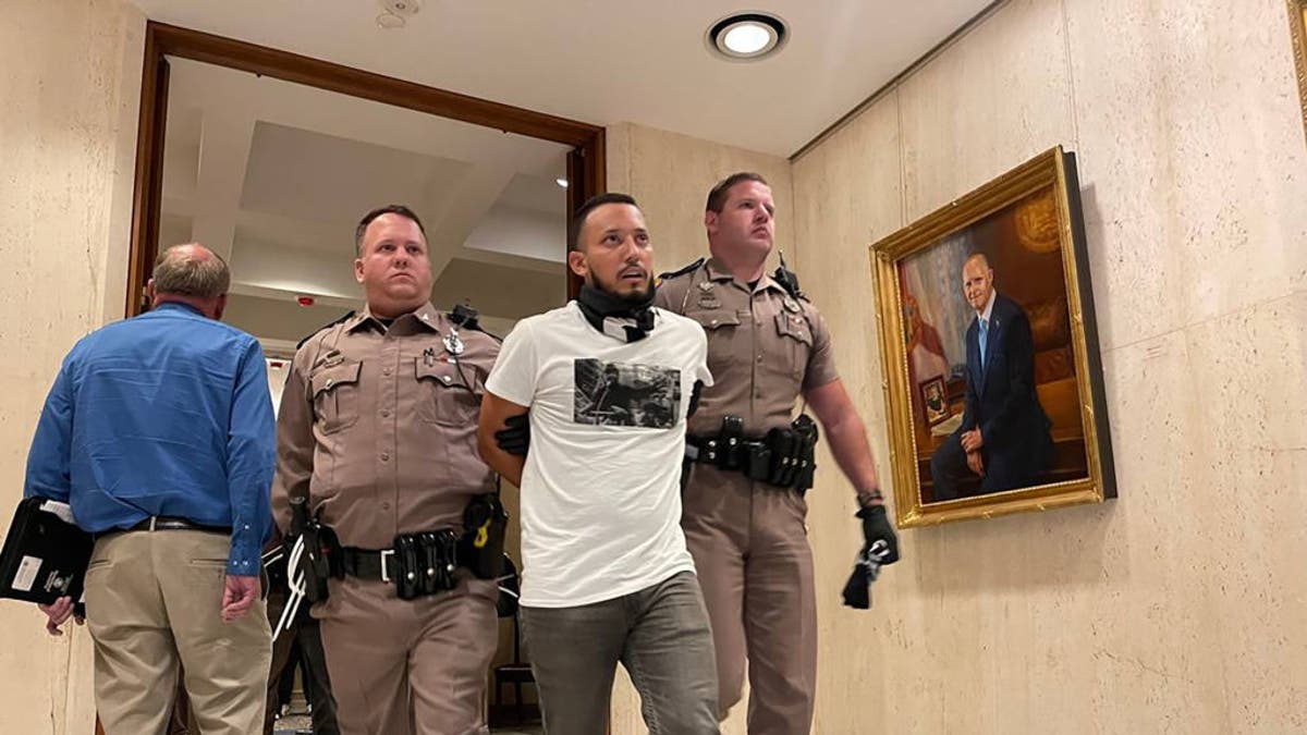 florida protesters being escorted out of desantis office