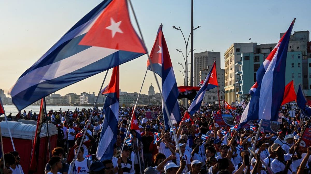 Demonstrators wave Cuban flags