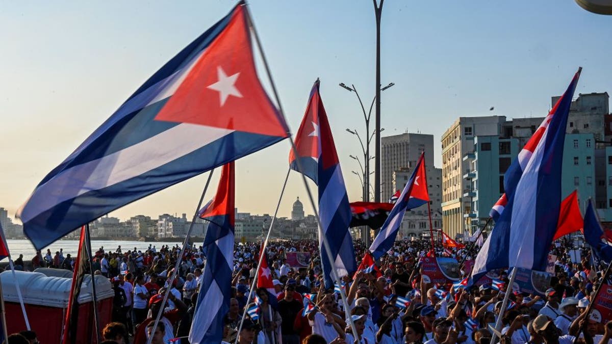 Demonstrators wave Cuban flags