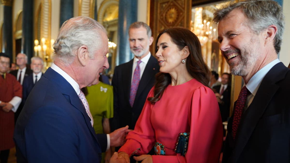 King Charles III (L) greets Mary, Crown Princess of Denmark and Crown Prince Frederik of Denmark,