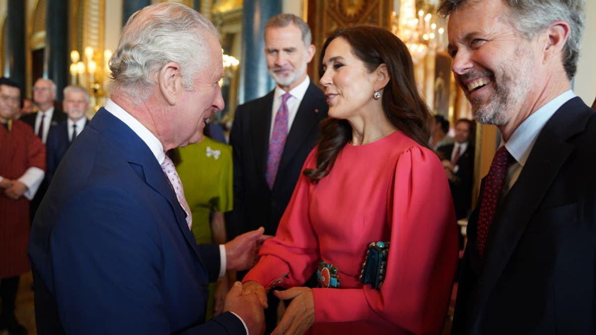 King Charles III (L) greets Mary, Crown Princess of Denmark and Crown Prince Frederik of Denmark,