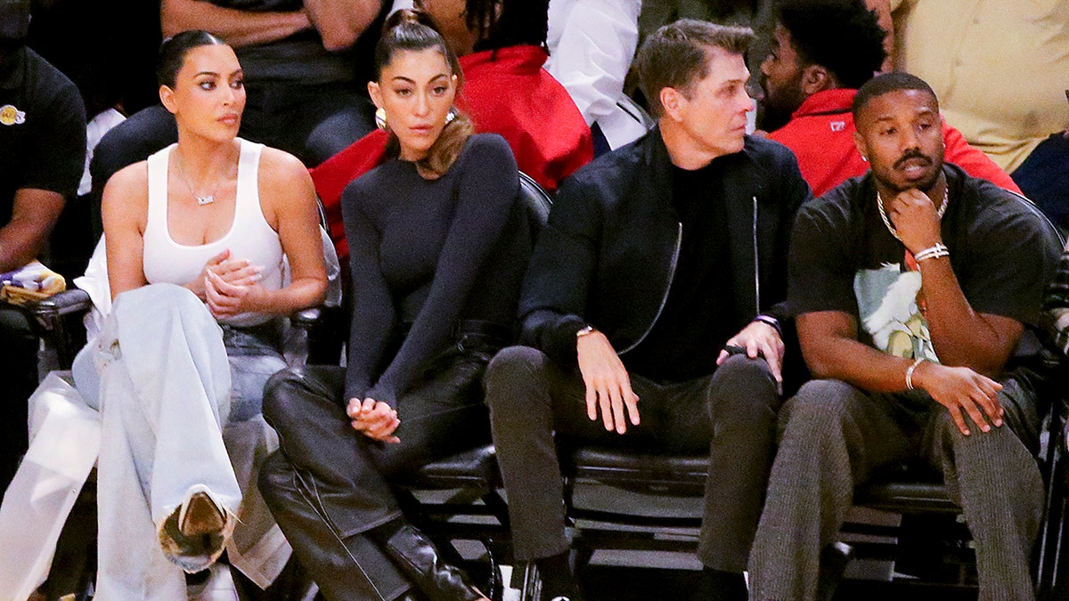 Kim Kardashian sits next to designer Sarah Staudinger and two people over is Michael B. Jordan, all sitting courtside at the Lakers game