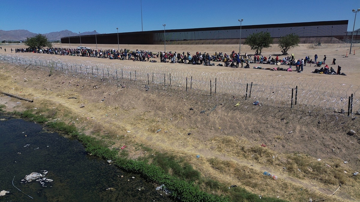 Migrants wait at the border
