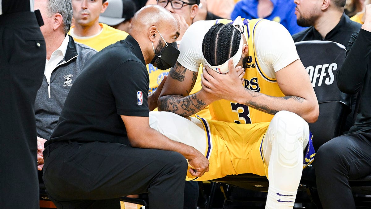 Anthony Davis gets checked by a trainer