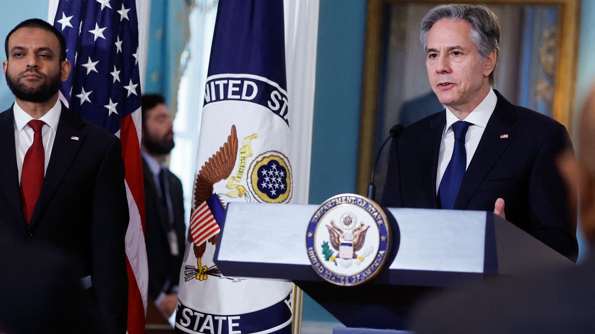 Blinken speaking at lectern 