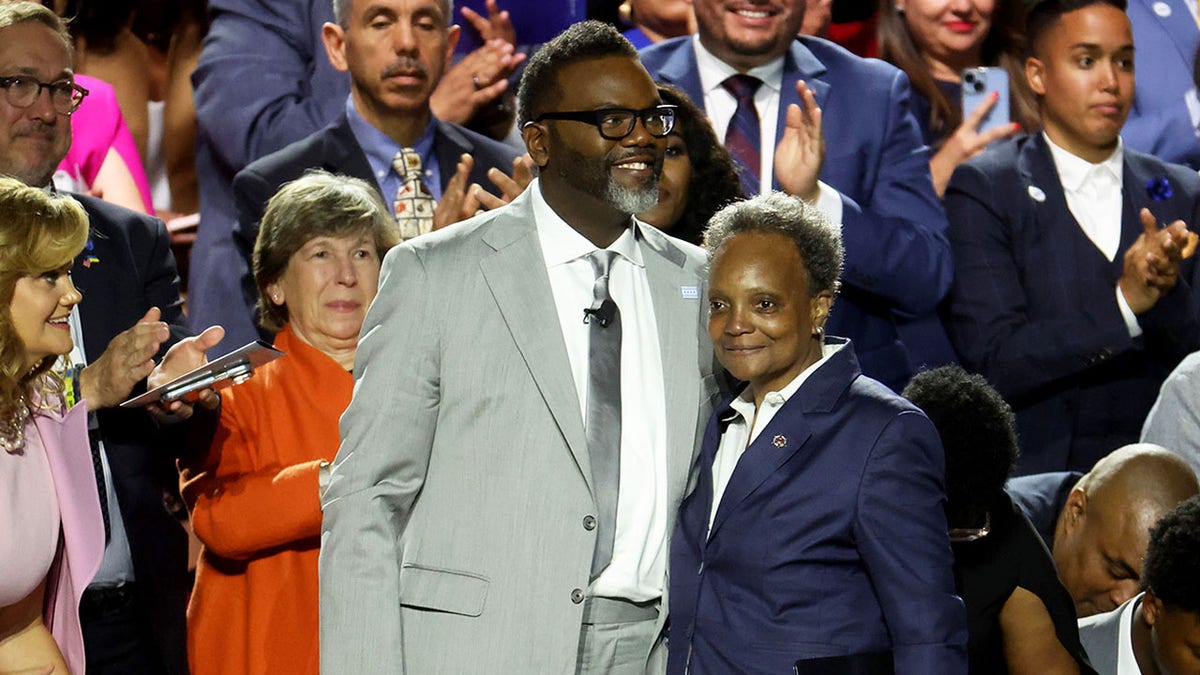 Brandon Johnson, left, stands with Lori Lightfoot at swearing-in ceremony