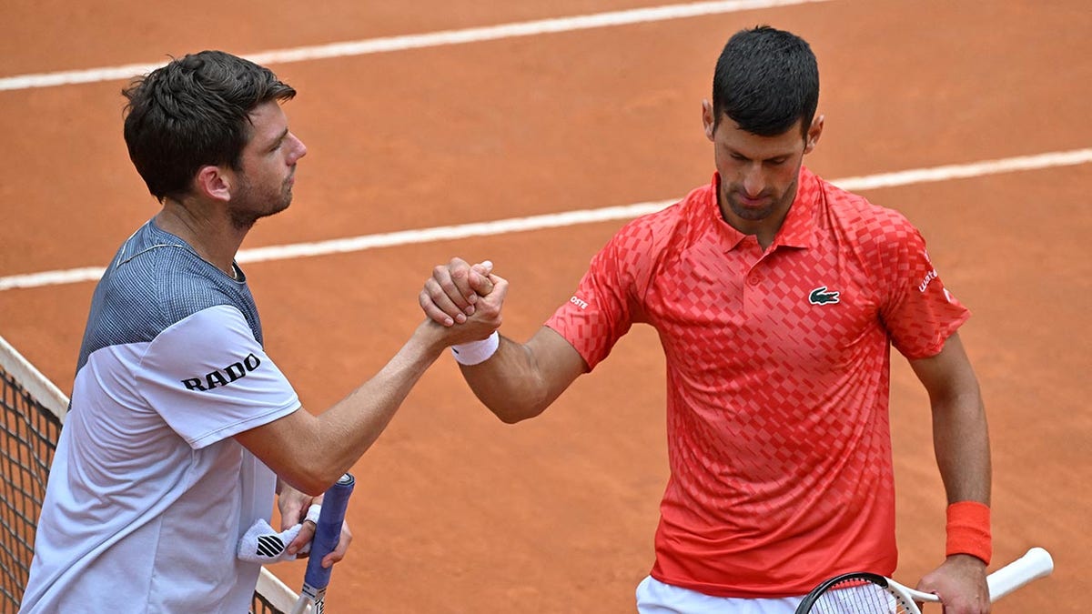 Cameron Norrie and Novak Djokovic shake hands at the Italian Open