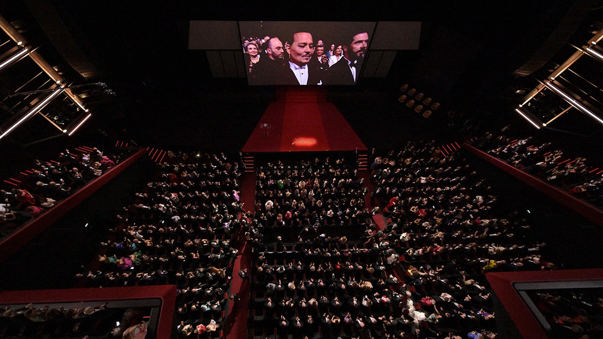 A birds eye view of the theater at Cannes which was previewing Johnny Depps film, shows Depp on the big screen getting emotional