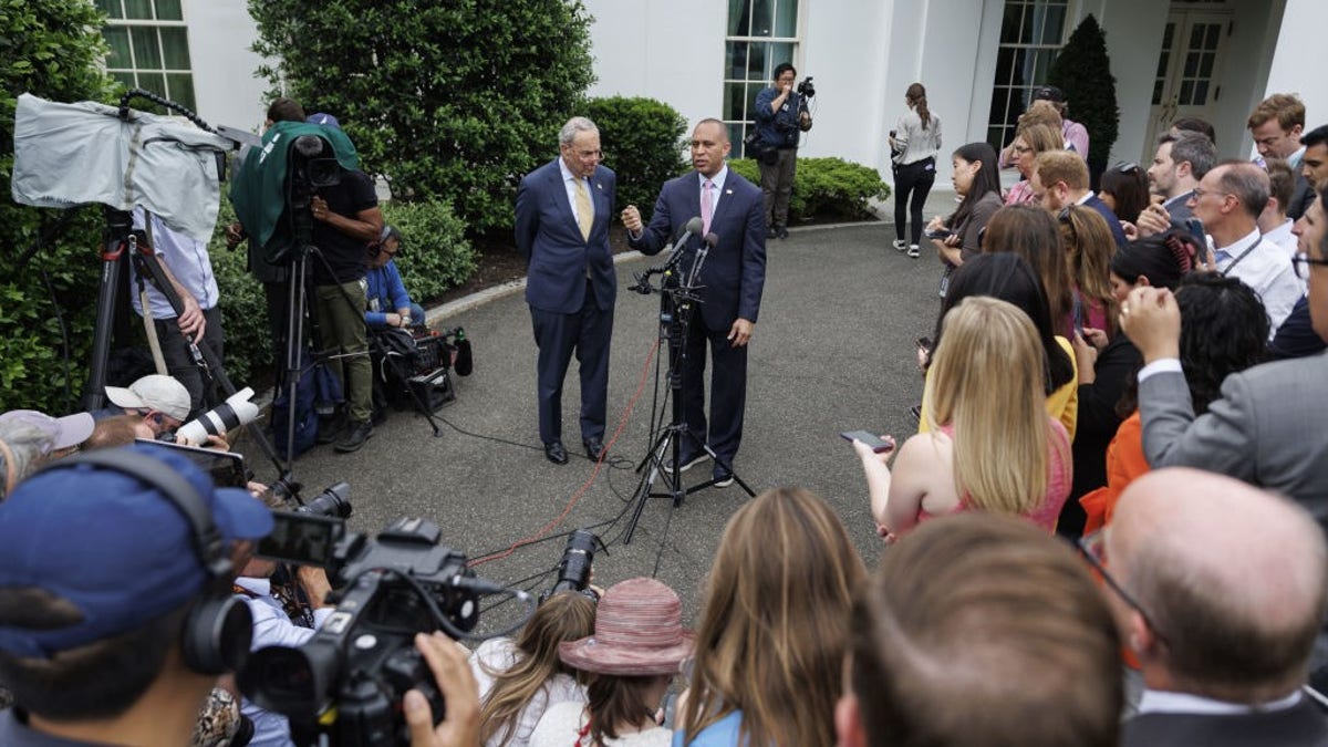 Representatives taking questions outside at a mic