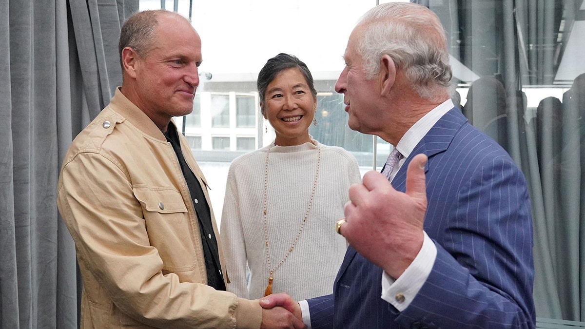 King Charles shakes hands with Woody Harrelson