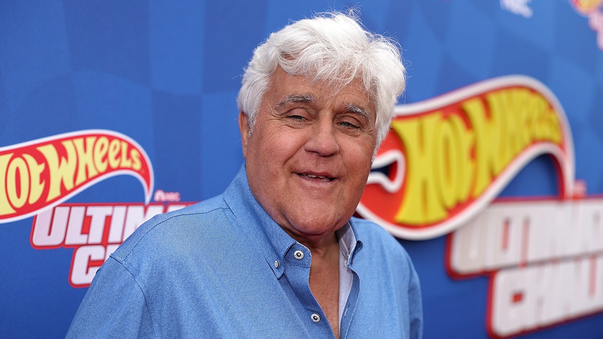 Jay Leno in a jean shirt smiles in El Segundo, CA at a HOT WHEELS event