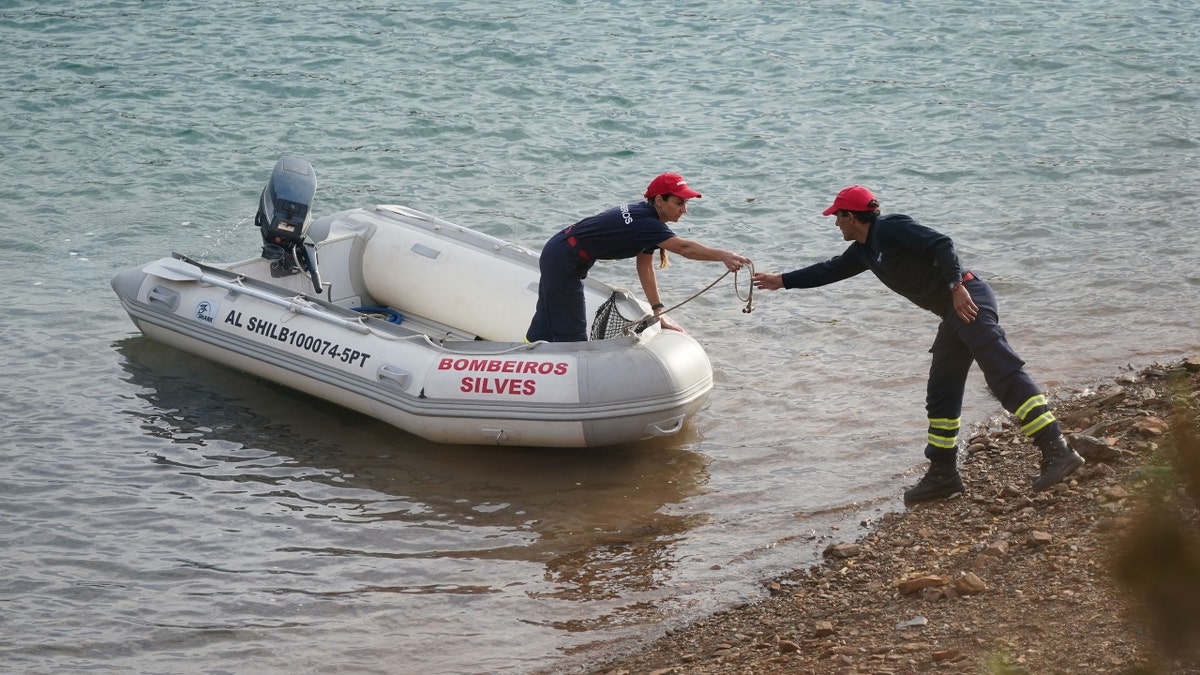 Investigators on a boat in the Arade dam