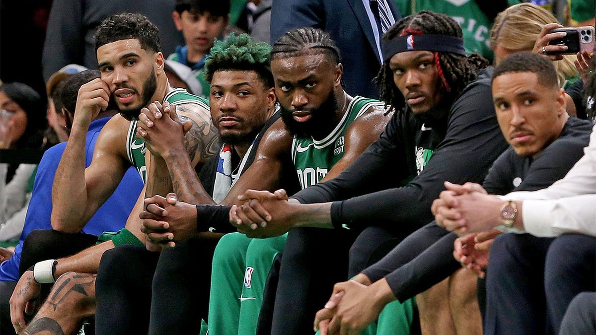 The Celtics sit on the bench during Game 7