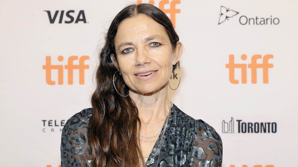 Justine Bateman soft smiles at the Toronto International Film Festival wearing large hoop earrings 