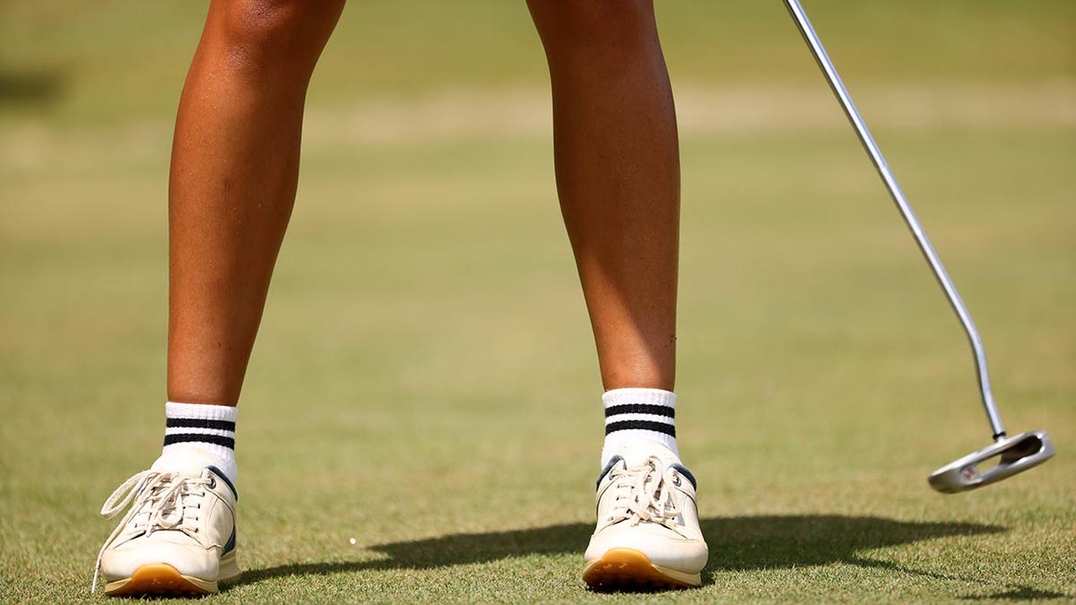 A golfer putts at the 2022 Division III Women's Golf Championship