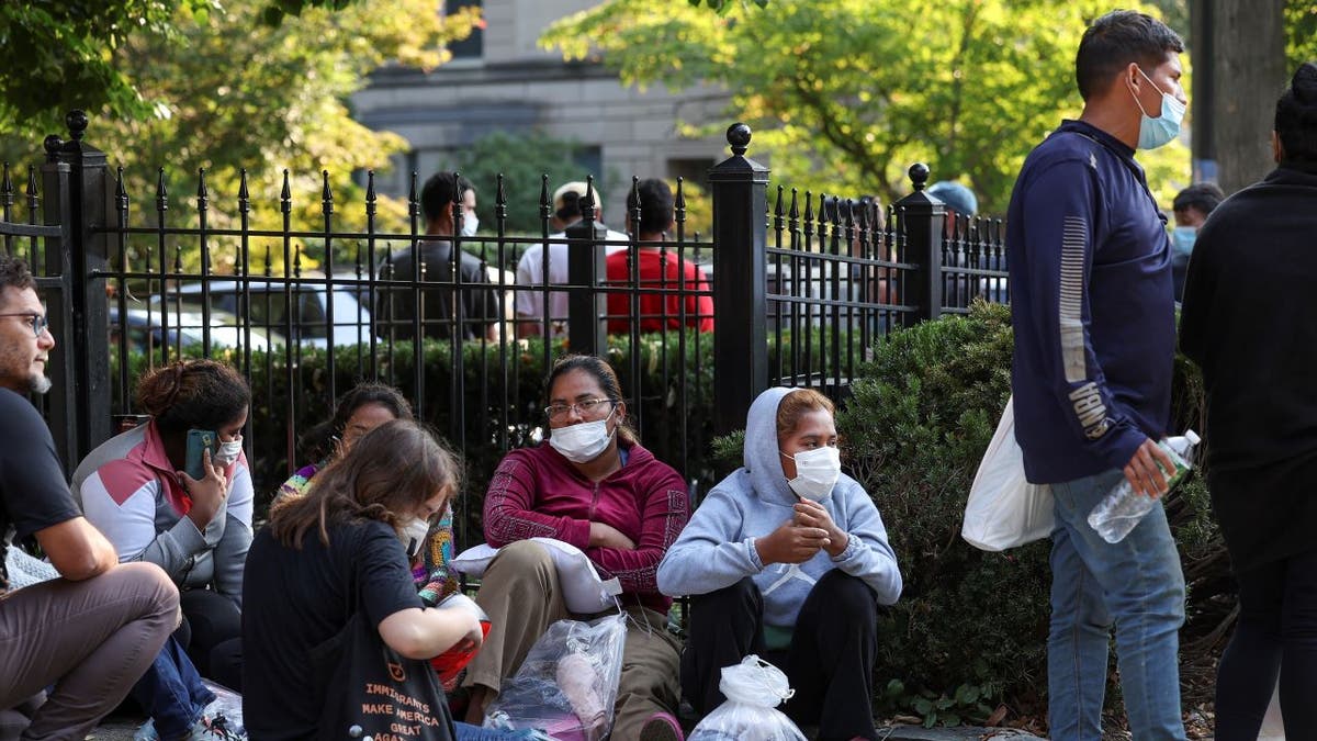 Migrants sitting outside VP's house