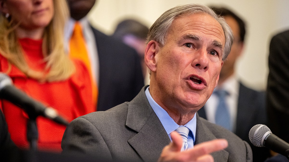 Gov. Greg Abbott, R-Texas, speaking into microphone