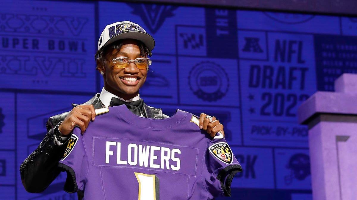 Zay Flowers poses after getting drafted by the Ravens