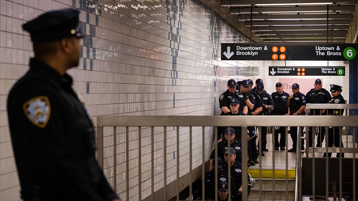 NYPD officers amid Jordan Neely vigil