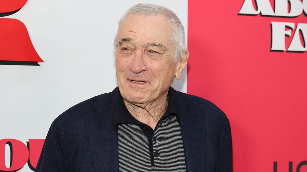 Robert De NIro looks off to his right and smiles while in New York City for the premiere of his film "About My Father"