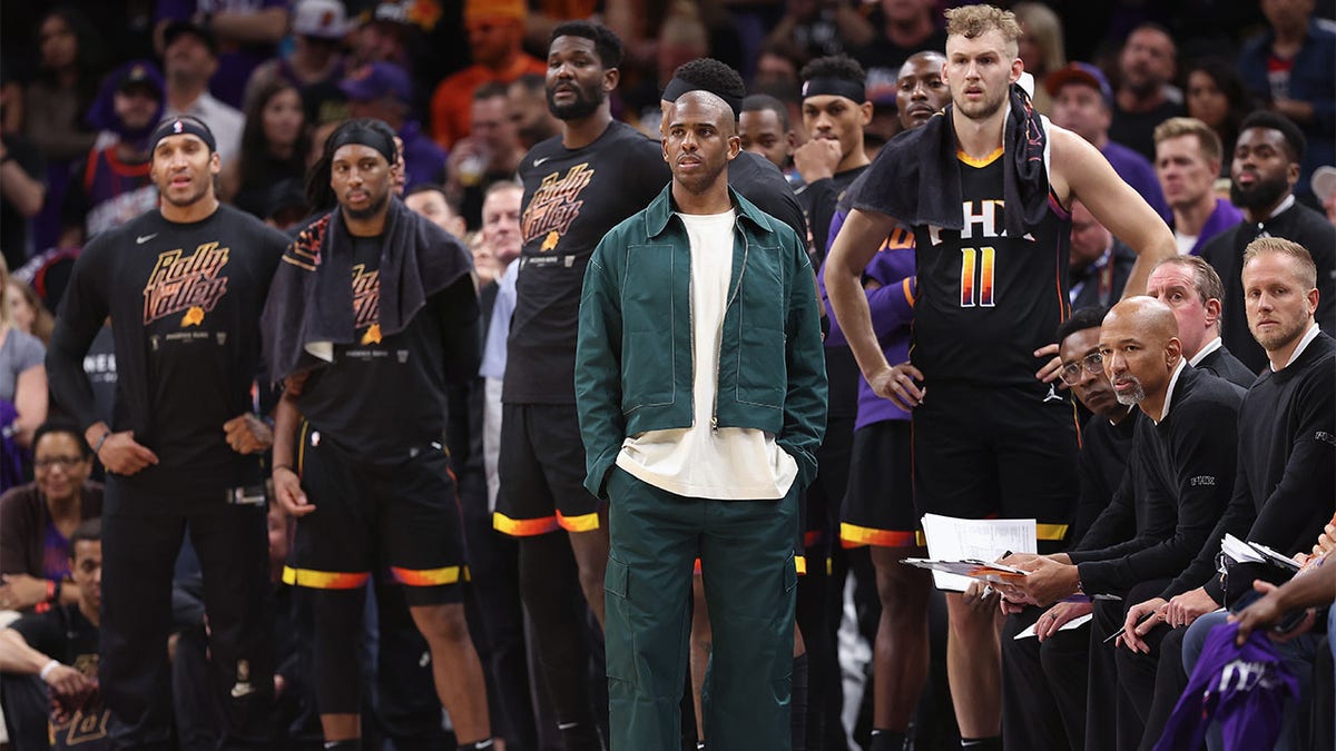 Chris Paul looks on from the bench