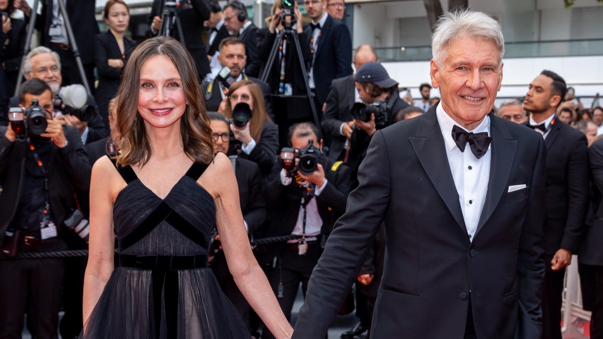 Calista Flockhart and Harrison Ford attend the "Indiana Jones And The Dial Of Destiny" red carpet during the 76th annual Cannes film festival at Palais des Festivals.