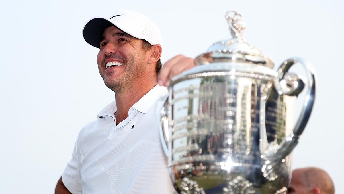 Brooks Koepka poses with the PGA Championship trophy