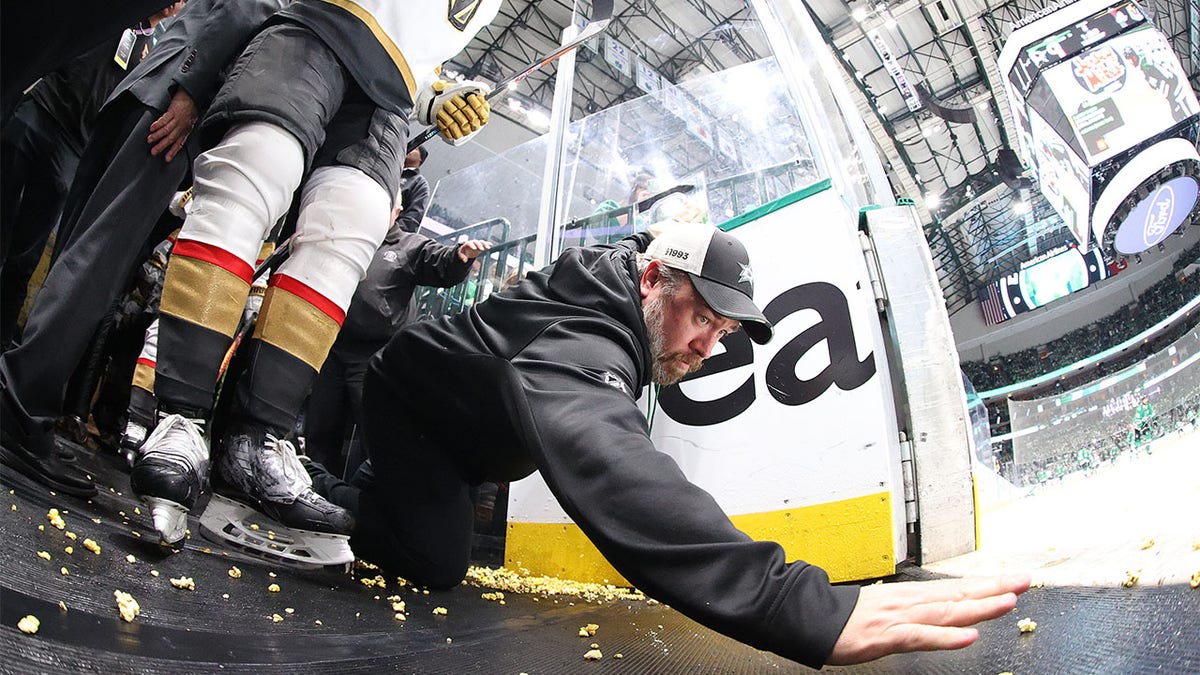 A Vegas staff member attempts to clean up popcorn
